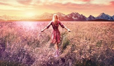 Woman walking through field