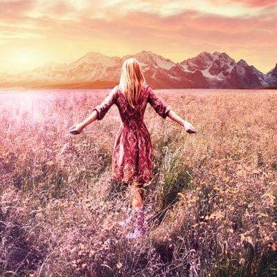 Woman walking through field