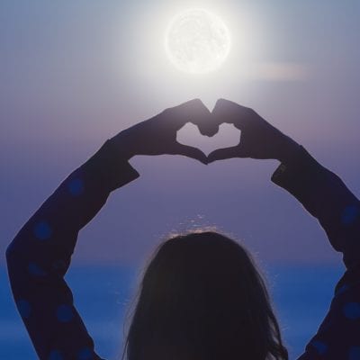 Woman making heart shape with hands